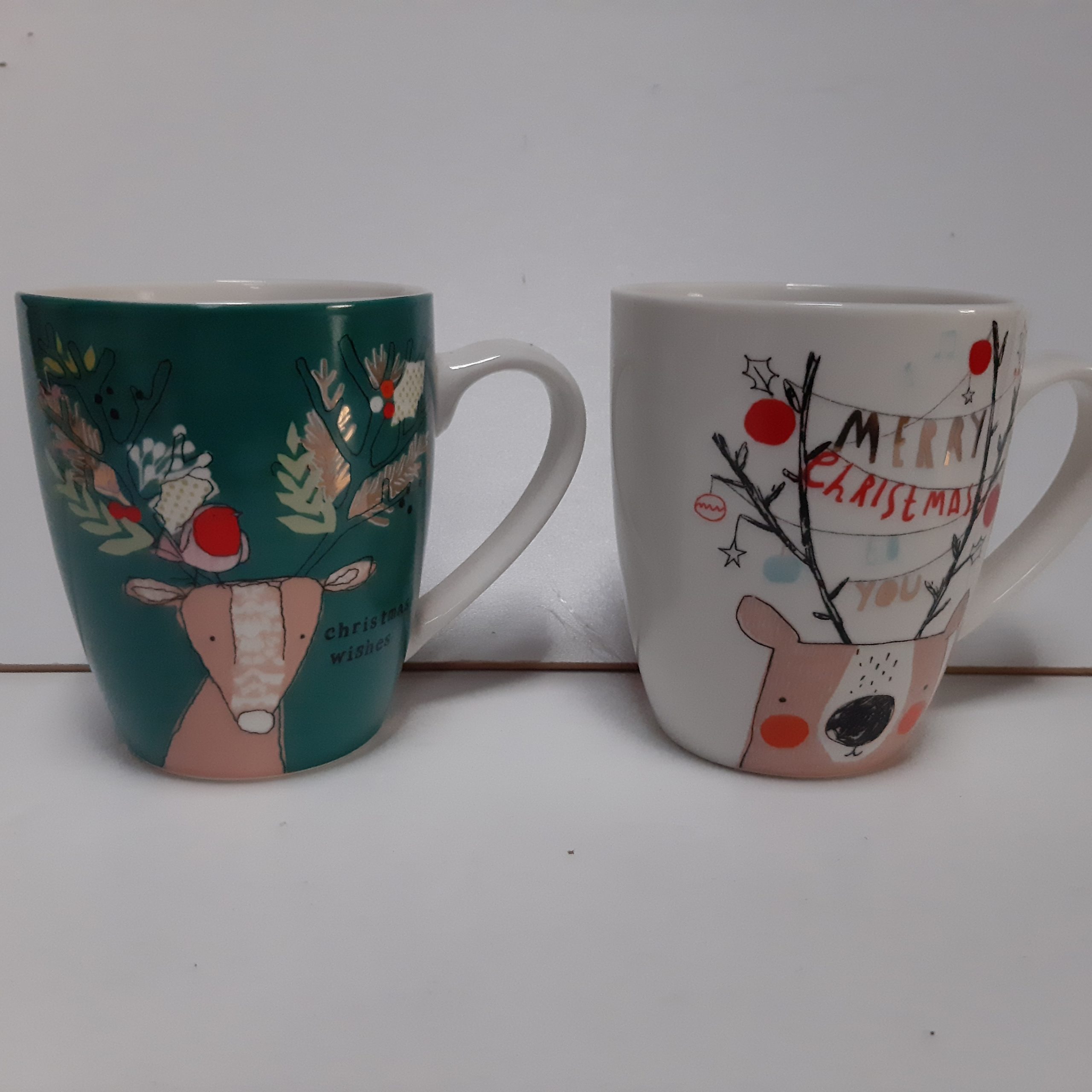 Set van 2 mokken met kerstwensen. 1 groen en 1 witte mok.